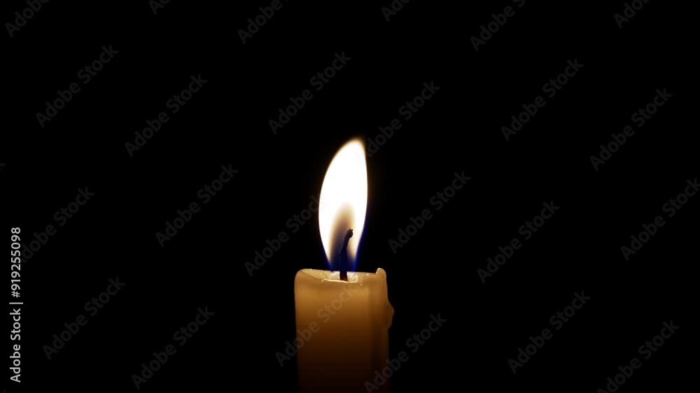 A calming moment unfolds with a gentle candle flame dancing in the darkness, creating an atmosphere of warmth and peace. A calming moment unfolds with a gentle candle flame dancing in the darkness, creating an atmosphere of warmth and peace.