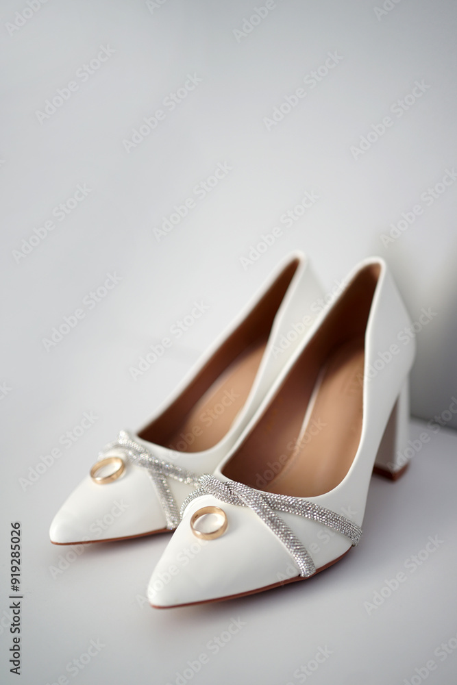Beautiful shoes of the bride and two wedding rings. Preparation for the wedding. Beautiful shoes of the bride and two wedding rings. Preparation for the wedding.