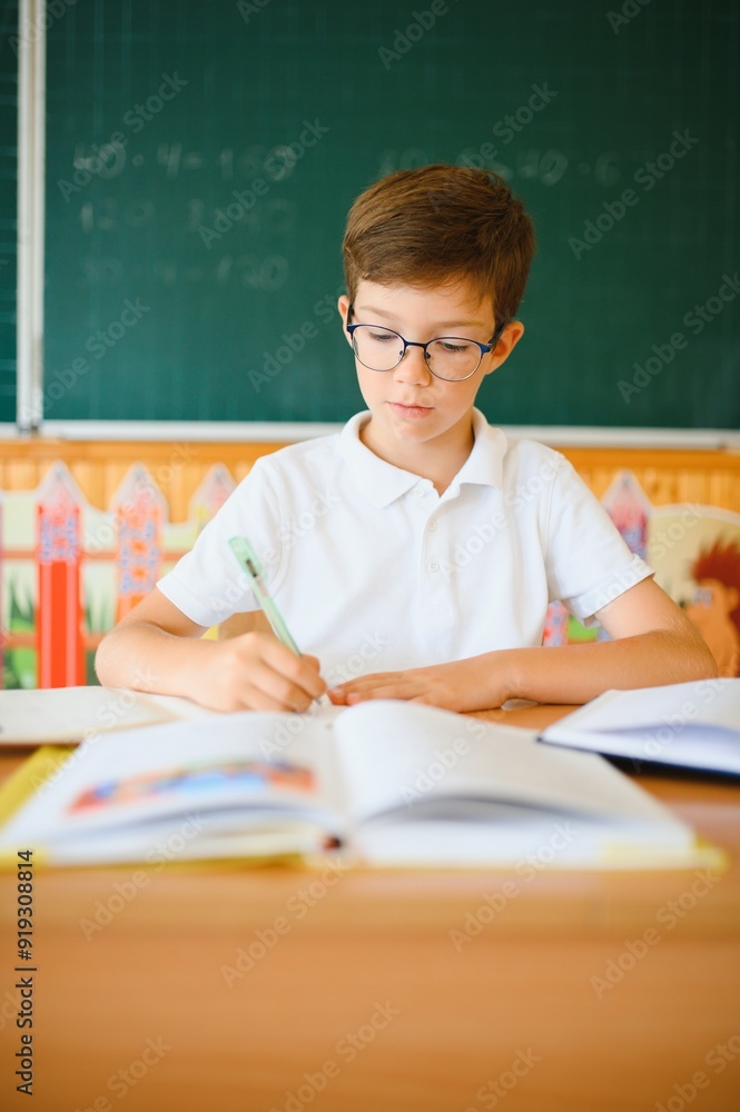 Portrait of little boy studying in classroom at school Portrait of little boy studying in classroom at school