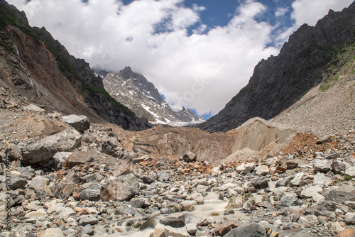 Melt waters of the Becho Glacier. Water flowing from the glacier on Ushba mountain. 
Dolra River in Becho Valley with panoramic views of Ushba Mountain. River photos taken with long exposure. photo