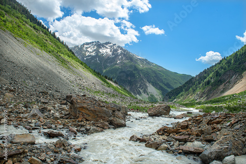 Melt waters of the Becho Glacier. Water flowing from the glacier on Ushba mountain. 
Dolra River in Becho Valley with panoramic views of Ushba Mountain. River photos taken with long exposure. photo