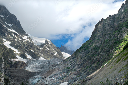 Melt waters of the Becho Glacier. Water flowing from the glacier on Ushba mountain. 
Dolra River in Becho Valley with panoramic views of Ushba Mountain. River photos taken with long exposure. photo