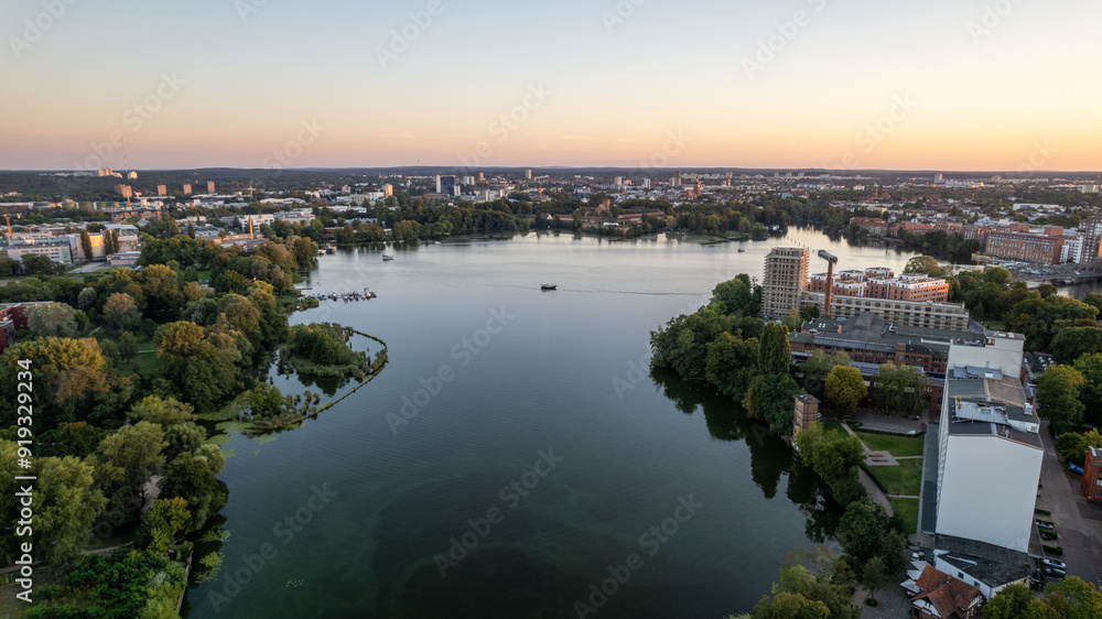 Fototapeta premium drone aerial view over Spandau Berlin in Germany over river HAvel on a sunny summer evening with sunset