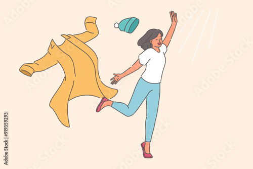Woman takes off winter clothes and runs towards sun rays, rejoicing at onset of summer or warming