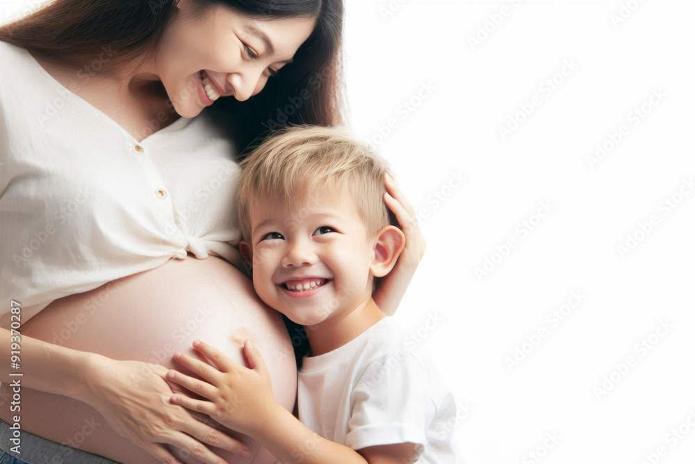 Cheerful smiling child put his ear to pregnant woman's belly on white background copy space Cheerful smiling child put his ear to pregnant woman's belly on white background copy space