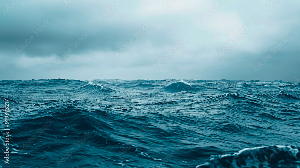 Cool toned ocean under moody sky. Concept of start of a storm in the ocean. Cool toned ocean under moody sky. Concept of start of a storm in the ocean.
