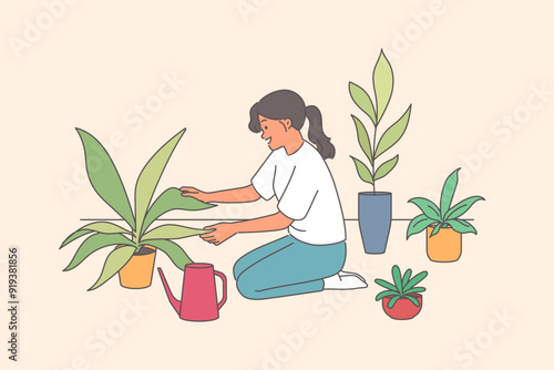 Woman florist takes care of house plants and carefully holds on to petals kneeling near watering can