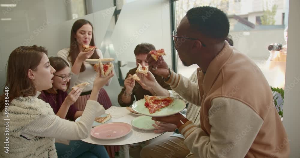 Mixed race, business team enjoying a pizza lunch break in modern office, bonding over food. Mixed race, business team enjoying a pizza lunch break in modern office, bonding over food.