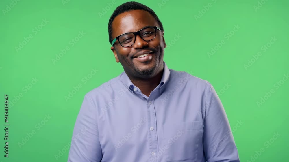 Middle-aged African American Male IT Manager with Glasses Smiling and Nodding on Green Screen Middle-aged African American Male IT Manager with Glasses Smiling and Nodding on Green Screen