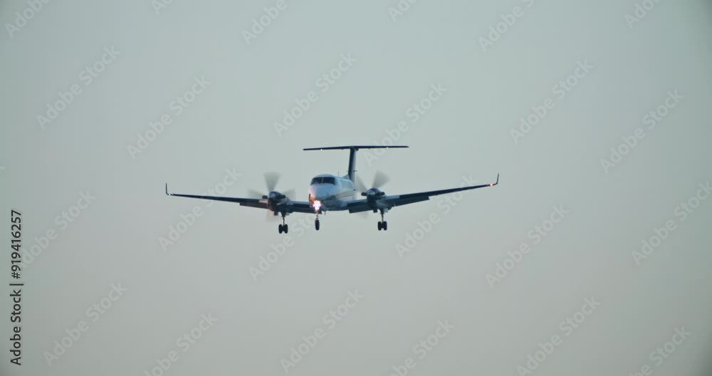 Slow motion video of a private plane landing at the airport. the plane flies in the sky delivering business tourists to the point of arrival. High quality 4k footage Slow motion video of a private plane landing at the airport. the plane flies in the sky delivering business tourists to the point of arrival. High quality 4k footage