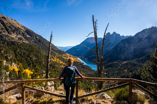 Young hiker woman in autumn in Aiguestortes and Sant Maurici National Park, Spain