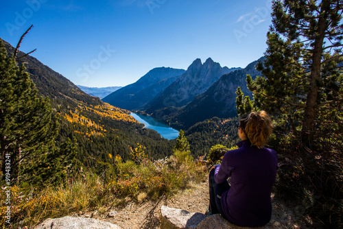 Young hiker woman in autumn in Aiguestortes and Sant Maurici National Park, Spain photo