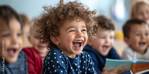 Happy little girl with curly hair laughing.