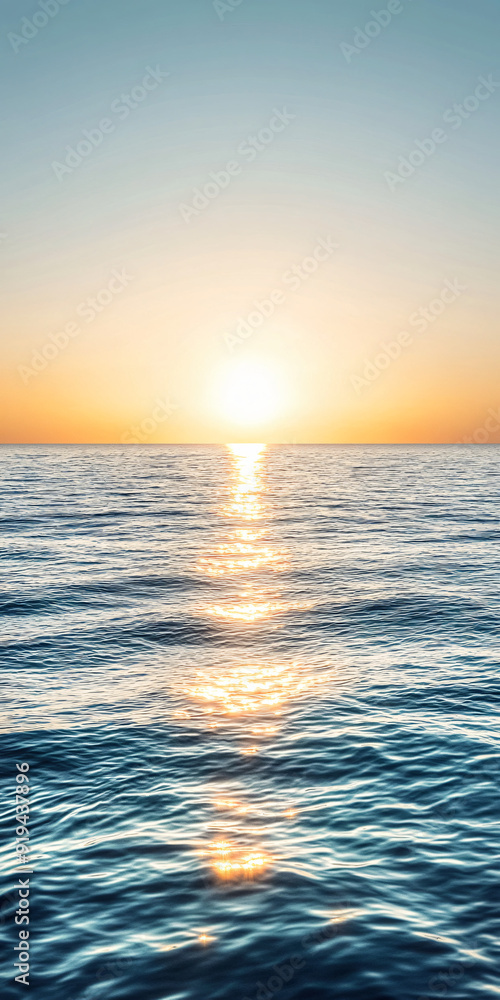 Fototapeta premium Bright sun rising over a calm ocean evoking hope