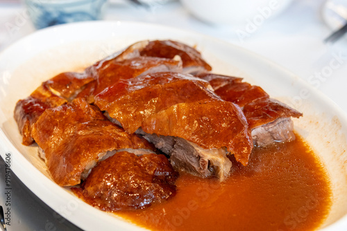 Photography Delicious roasted golden goose is cut into pieces and placed on a plate