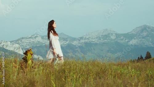 Wallpaper Mural Woman Walking and Sitting in a Mountain Meadow Torontodigital.ca