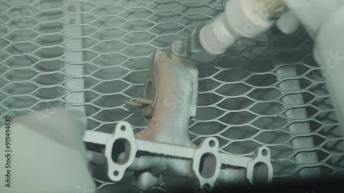 Close up cleaning and removing rust from car turbine turbocharger using a sandblasting machine
