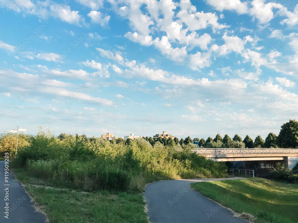 A bridge spans a river with a green field on either side A bridge spans a river with a green field on either side
