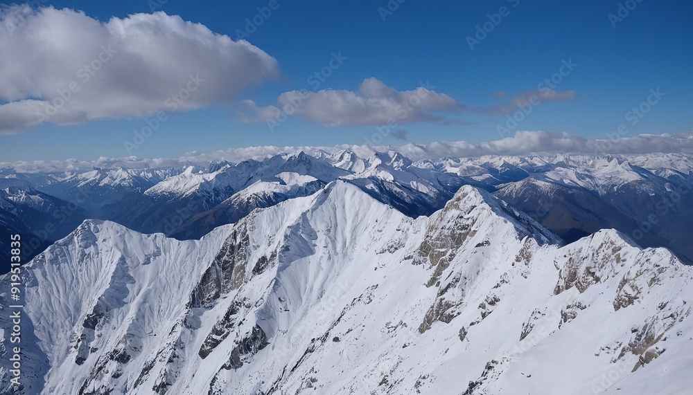 Obraz premium Majestic snowcapped mountains against a blue sky 12