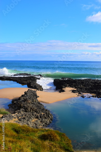 Spectacular backwash from the Indian Ocean waves breaking on basalt rocks at Ocean Beach ,Bunbury ,Western Australia on a sunny morning in early winter. July 21 2022.