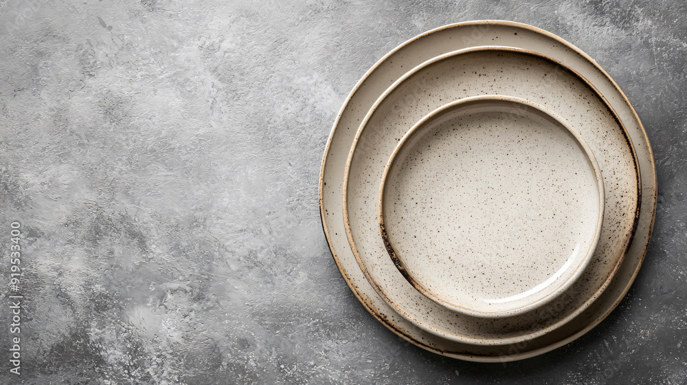 Beautiful Beige Ceramic Plates on Gray Textured Table Beautiful Beige Ceramic Plates on Gray Textured Table