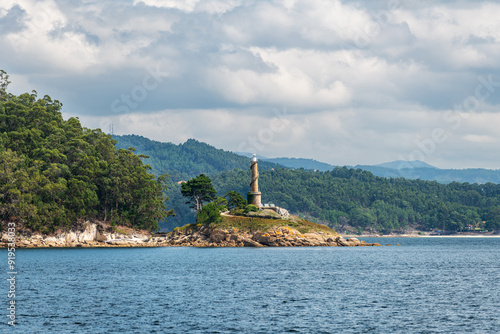 Lighthouse of the Tambo Island as seen from a boat in the Ria de Pontevedra in Galicia, Spain. Formerly a Naval Military School base, since 2022 it serves as a natural and cultural destination.