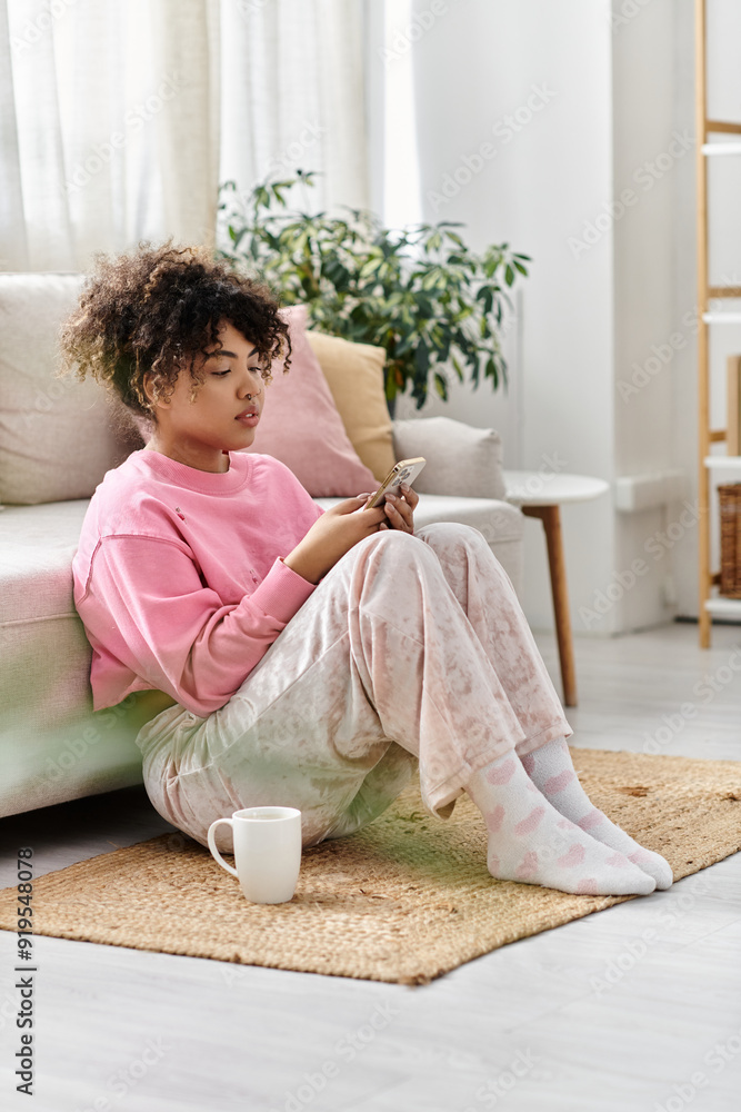 A young woman enjoys a peaceful moment at home, engrossed in her phone. A young woman enjoys a peaceful moment at home, engrossed in her phone.