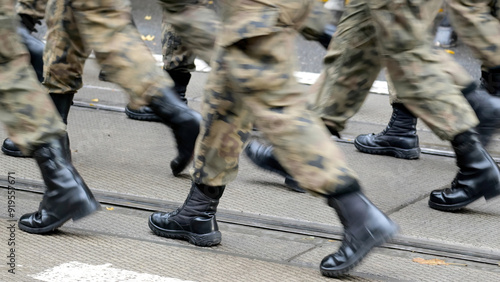 Fotografija Anonymous army soldiers marching through the street in generic camo uniforms and
