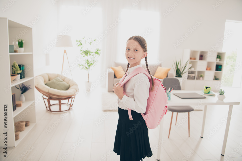 Photo of cute small schoolkid backpack wear uniform living room apartment indoors Photo of cute small schoolkid backpack wear uniform living room apartment indoors