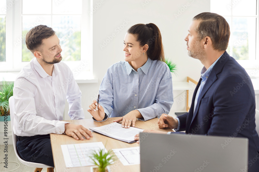 Business people colleagues sitting at the desk on workplace in office discussing new project, reaching agreement and going to sign a contract making a deal. Partnership and teamwork concept. Business people colleagues sitting at the desk on workplace in office discussing new project, reaching agreement and going to sign a contract making a deal. Partnership and teamwork concept.