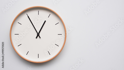 Minimalist wooden Wall Clock on White Wooden Surface with Space for Text – Time Set at 13.55/01.55