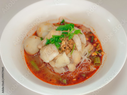 A captivating image of a bowl of noodles, beautifully presented with a variety of fresh ingredients and garnishes. The rich textures and vibrant colors make it an enticing visual for food enthusiasts