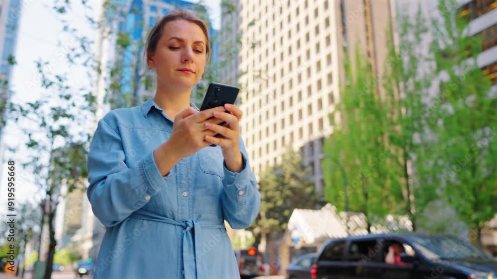 Caucasian woman is walking around the city and using smartphone. Slow motion Caucasian woman is walking around the city and using smartphone. Slow motion