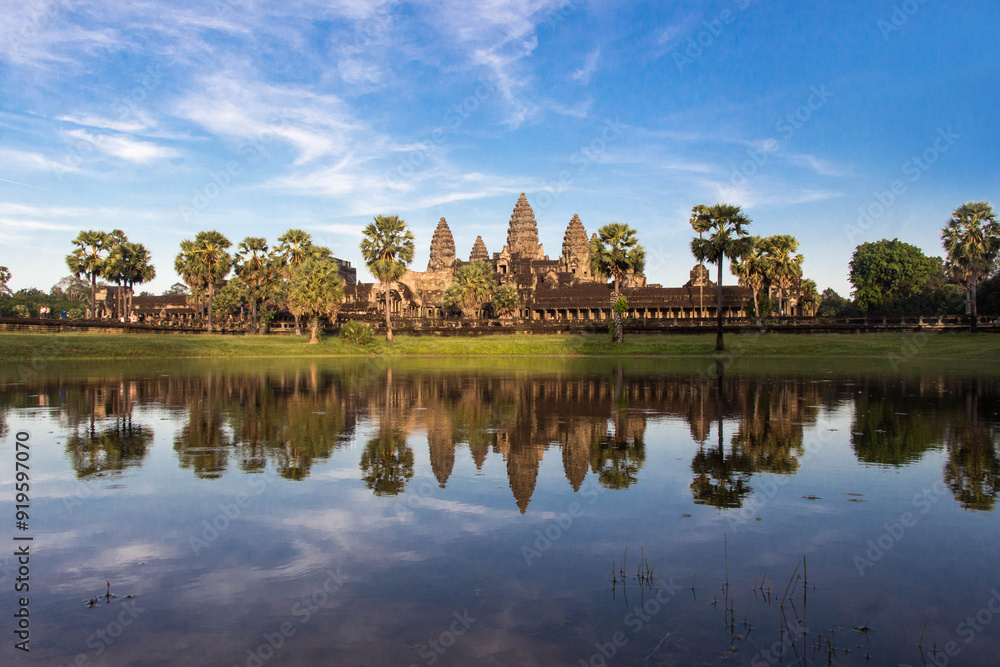 Naklejka premium ANGKOR WAT, SIEM REAP, CAMBODIA - NOVEMBER 16, 2016: Angkor Wat in Cambodia is a majestic ancient temple complex, known for its stunning sunrise views, intricate carvings, and rich history.