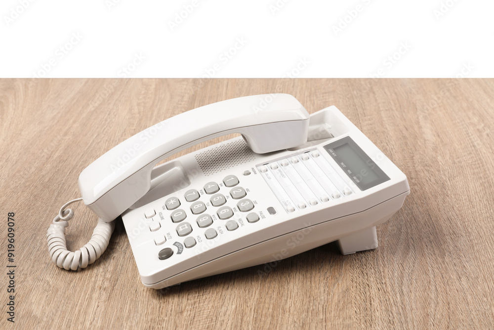 Telephone on wooden table against light background Telephone on wooden table against light background