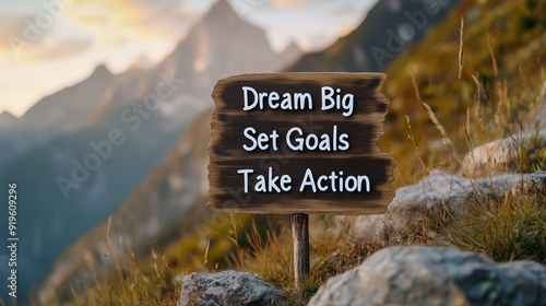 dream big , set goals, take action on wooden board with mountain landscape on background  photo