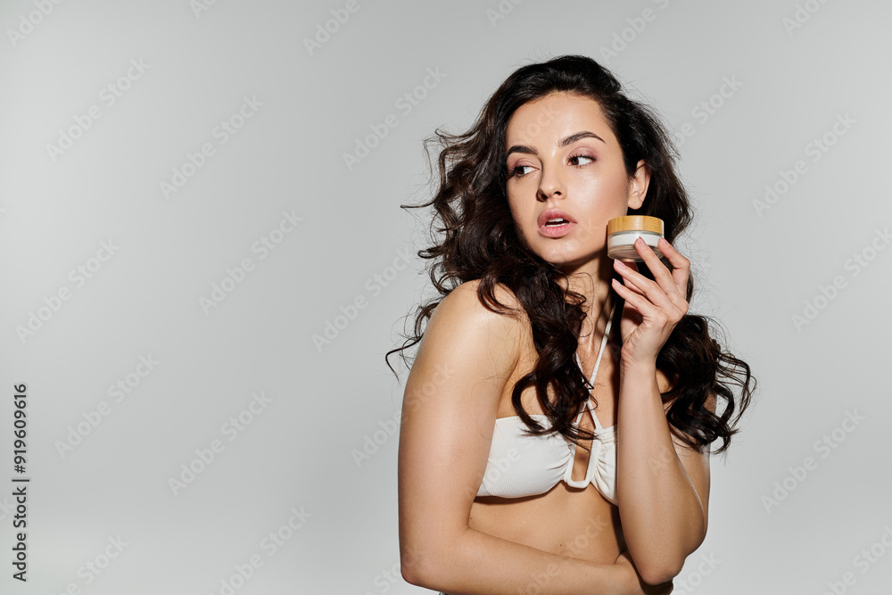 A young woman highlights her skincare routine with grace and elegance. A young woman highlights her skincare routine with grace and elegance.