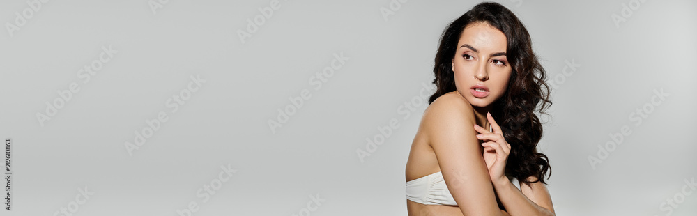 Attractive woman poses confidently on white backdrop. Attractive woman poses confidently on white backdrop.