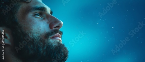  A man with a beard gazes into the distance, his intense gaze contrasting with the gentle rainfall Water droplets bead on the surface of the sky behind him