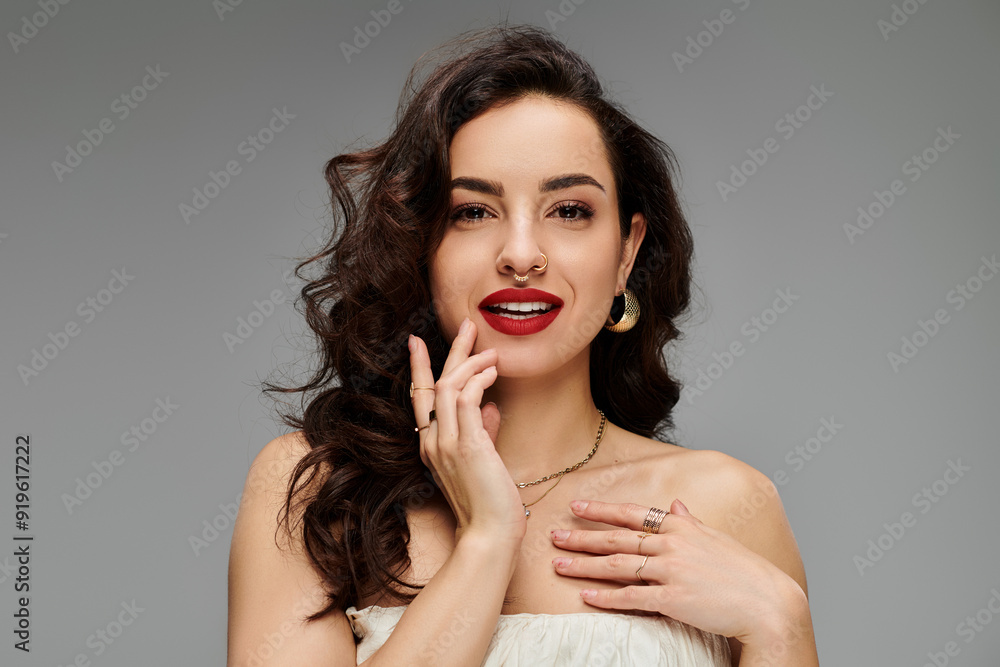 A young woman showcases her jewelry with a radiant smile and lively expression. A young woman showcases her jewelry with a radiant smile and lively expression.