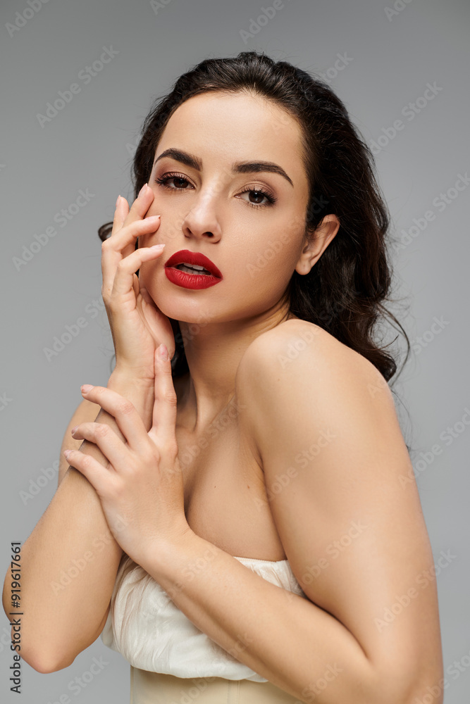 A beautiful young woman poses gracefully.