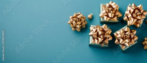  A collection of gift-wrapped presents sits atop two separate blue tables The first table holds a group of presents, while the second table is home to a stack of golden-wrapped