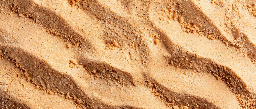 A tight shot of a sandy texture, featuring a modest mound of sand in the foreground and a faint layer in the backdrop A tight shot of a sandy texture, featuring a modest mound of sand in the foreground and a faint layer in the backdrop