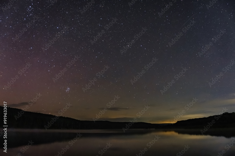 starry sky over the lake on a summer night starry sky over the lake on a summer night
