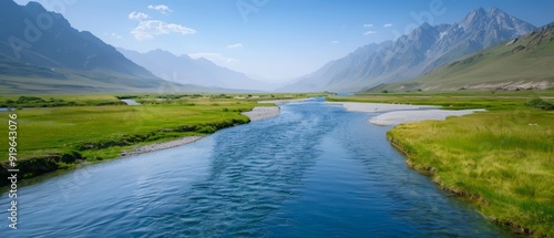  A river runs through a verdant valley, surrounded by lush green grass and towering mountains