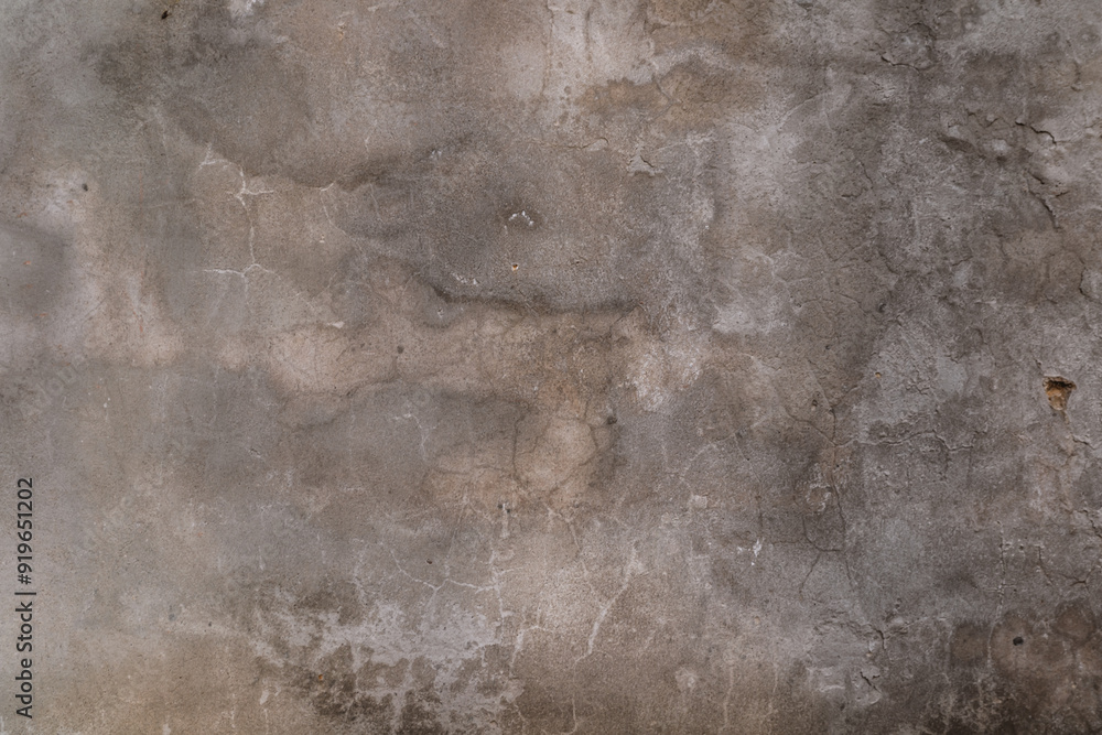 Fototapeta premium A grey wall with cracks and holes