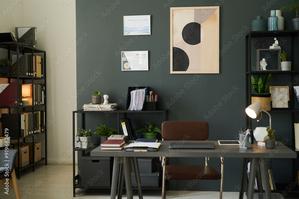 Well-organized modern office with green accents, open shelves, tidy desk with lamp and computer, neutral tones, creating welcoming and productive atmosphere Well-organized modern office with green accents, open shelves, tidy desk with lamp and computer, neutral tones, creating welcoming and productive atmosphere