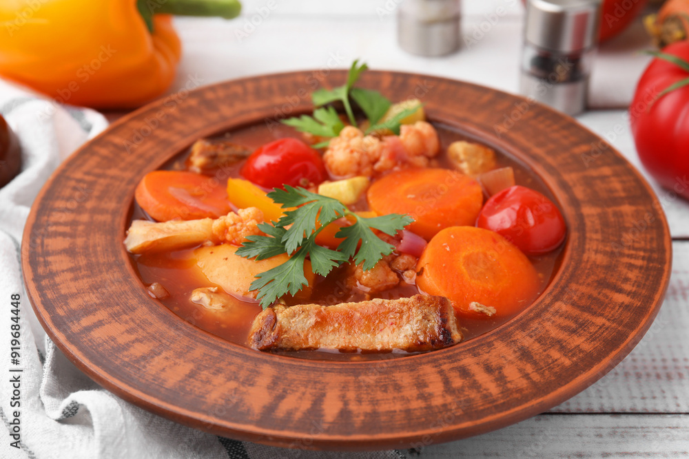 Tasty homemade stew with vegetables on white wooden table, closeup Tasty homemade stew with vegetables on white wooden table, closeup