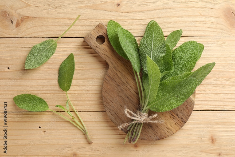 Bunch of fresh sage leaves on wooden table, flat lay Bunch of fresh sage leaves on wooden table, flat lay