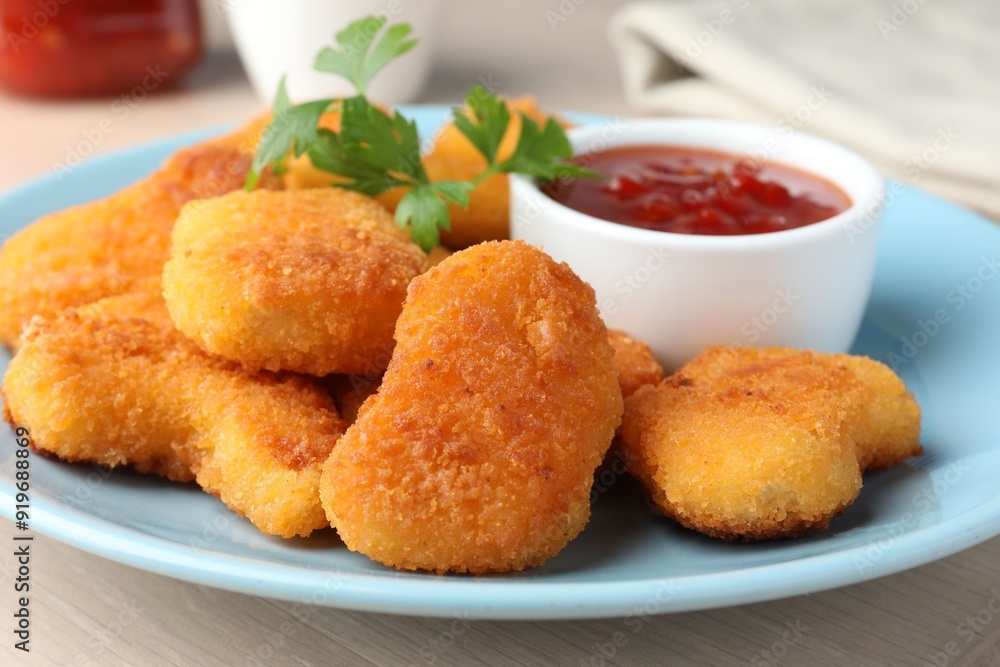 Tasty chicken nuggets with chili sauce and parsley on table, closeup Tasty chicken nuggets with chili sauce and parsley on table, closeup